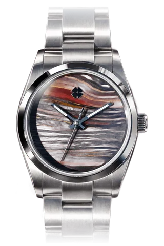 Cadran en pierre veinée de rouge, d’ocre et de bleu, boîtier et bracelet en acier.